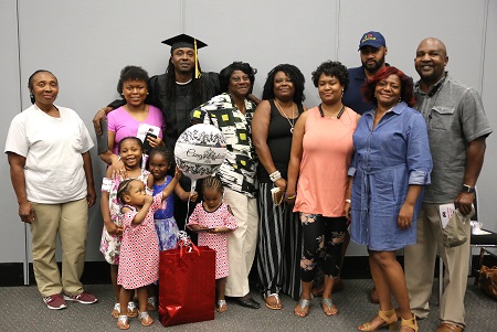 Maben resident Roger Jones, at center, with members of his family following the graduation ceremony for students who earned their high school equivalency diploma through East Mississippi Community College’s Adult Basic Education Launch Pad program.