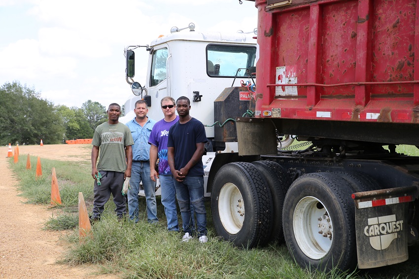 East Mississippi Community College’s Commercial Truck Driving program student Ronald Gore of Columbus, Chris Lovelace of Webster County, program instructor Mark Dodson, and student Montavious Walker stand beside a dump truck donated by Phillips Contracting. Commercial Truck Driving will now include training on the use of construction equipment.
