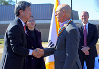 Republic of Korea Consul General Hyung Gil Kim, at left, presents Korean War veteran Antoine Otto with the Ambassador for Peace Medal for his service.