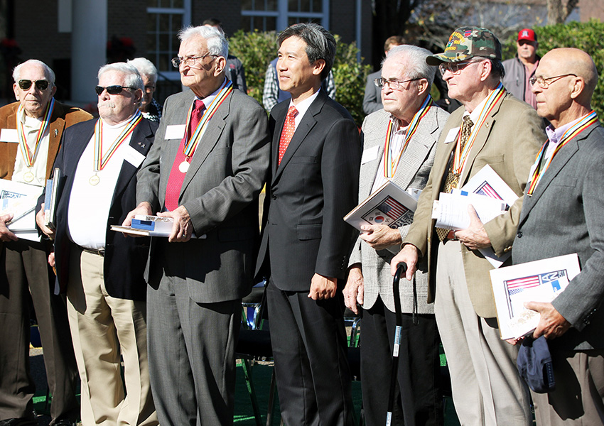 Republic of Korea Consul General Hyung Gil Kim, at center, with veterans he presented with the Ambassador for Peace Medal for their service to his country during the Korean War.