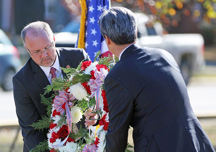 East Mississippi Community College President Dr. Thomas Huebner, at left, and Republic of Korea Consul General Hyung Gil Kim prepare to lay a wreath at the Korean War memorial on the college’s campus.