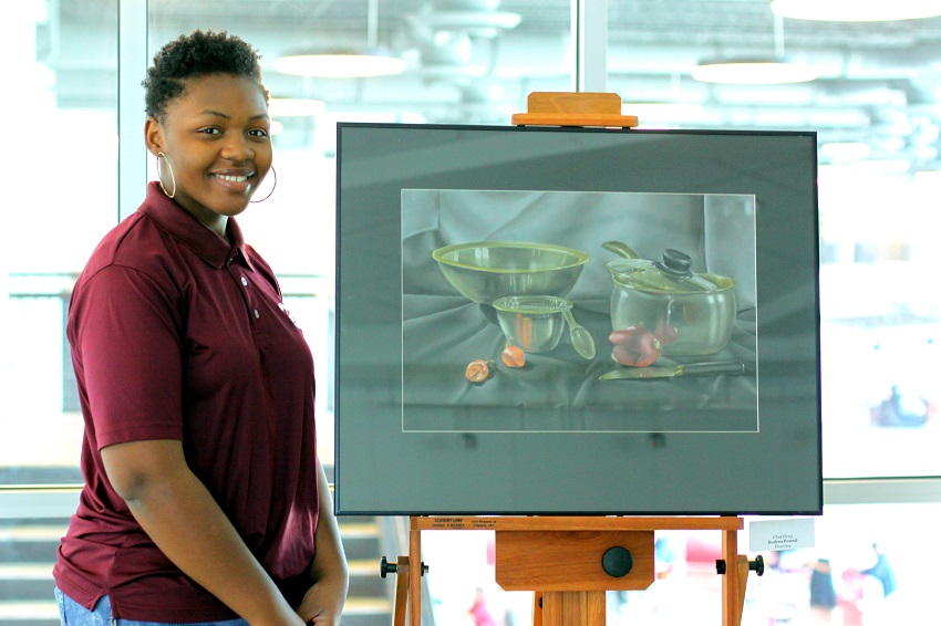 EMCC art student Audrea Powell with her drawing titled “Chef Greg,” that earned her third place in drawing in the Mississippi Community and Junior College Art Instructors Association State Art Competition. Powell immersed herself in art following the death of her mother.