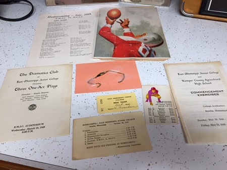 Items donated to EMCC's archives include various school documents from their years at the college, such as a meal ticket, football schedule, and pamphlets of a commencement exercise and a play presented by The Dramatics Club.