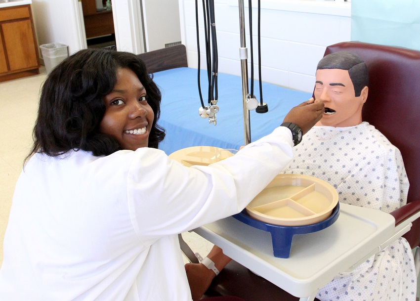 Student applications are being accepted for East Mississippi Community College’s Certified Nursing Assistant program on the Scooba campus. In this file photo, a former student practices feeding a simulated patient care mannequin during training. 