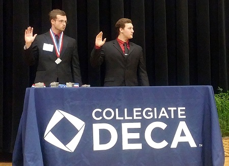 EMCC students Clayton Forrester, at left, and Dalton Robison are sworn in as state officers for the Mississippi Collegiate DECA. Robison will serve as the state president for the organization, while Forrester will serve as vice president.