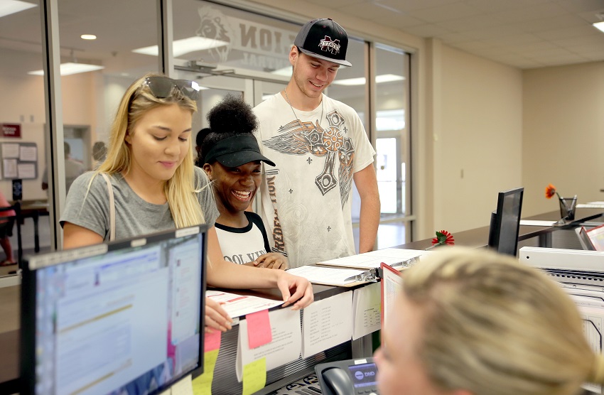 East Mississippi Community College incoming freshmen Brooke Johnson, at left, and Randy Miller, at right, enroll at Lion Central on the Golden Triangle campus. Both are from West Point, as is Tia Edwards, at center, a friend of Johnson’s who wanted more information about EMCC, where fall registration is under way.