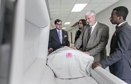 East Mississippi Community College Funeral Services Technology instructor Kevin Hurt, second from right, shows students Samuel Bertrand of Hamilton, Austyn Antley of Downsville, La., and Leonard Williams, Jr. of Columbus a casket in this photo taken from last year.