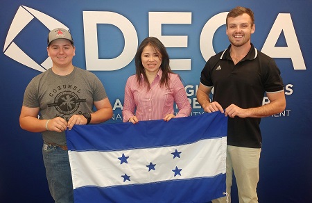 EMCC students, from left, Cody Troyer, Gissela Perdomo and Clayton Forrester at a Fall Leadership Conference in New York City. The students are holding the national flag of Honduras, which is Perdomo’s home country. 