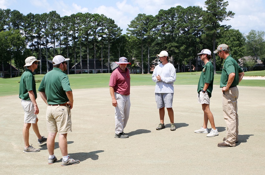 East Mississippi Community College Director of Golf Will Arnett, at center, inspects the grass on one of the greens at the Lion Hills Center & Golf Club. The grass on holes 1-9 has been killed and work is under way to convert the greens to Tif-Eagle, a high quality grass intended to improve putting speed and consistency. Arnett is joined, from left, by EMCC Golf / Recreational Turf Management students Tanner Jacobs of Caledonia, Hunter Calhoun of Madison, Winn Kent of Greenville, and Blake Miller of Starkville. Golf course superintendent Derek Havard is at the far right.