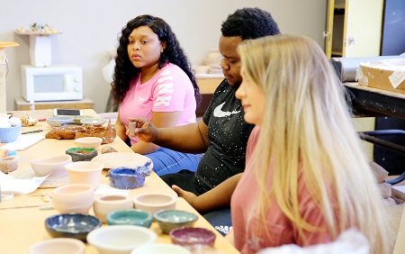 East Mississippi Community College students in art instructor Terry Cherry’s class work on pottery that will be for sale during the college’s Fine Arts Holiday Celebration Nov. 27. The students are, from left, Ciara Darden, Brandon Holmes and Jenna Brooke Hailey.