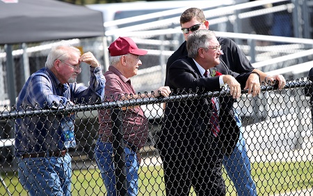 EMCC's 2018 Distinguished Service Award recipient Dewayne Hull, second from right, watches the college's Oct. 13 Homecoming game with friends from the visitors' sideline, which is where Hull can be found during most of the Lions' home games.