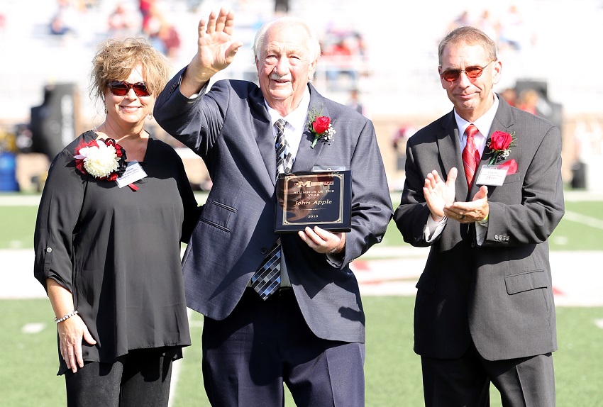 East Mississippi Community College Community College named Nashville, Tenn., resident John Apple, at center, the 2018 Alumnus of the Year Saturday, Oct. 13, during halftime of the college’s Homecoming game against Holmes Community College. Apple was presented with the award by EMCC Director of Alumni Affairs and Foundation Operations Gina Cotton, at left, and EMCC Alumni Association President Craig Hitt, at right. 