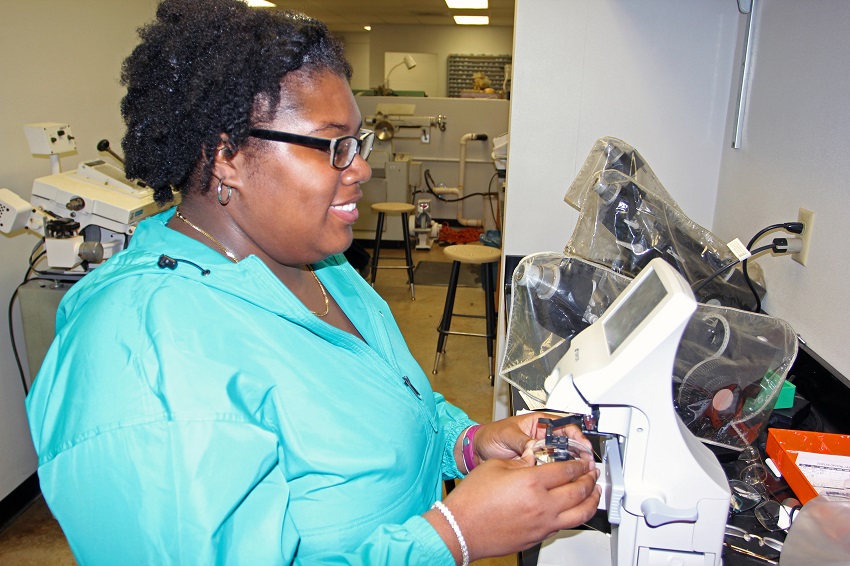 EMCC Ophthalmic Technology student Zaneshia Brandy works on a pair of eyeglasses which will be donated during an upcoming mission trip to Haiti by Shared Vision International of Lincoln, Neb.