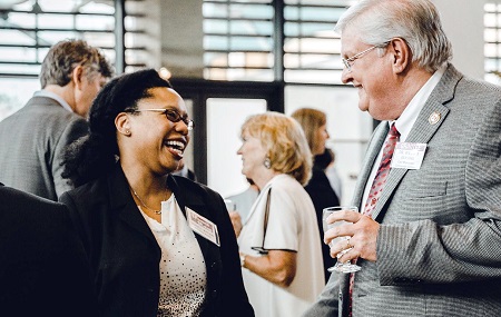 East Mississippi Community College Associate Dean of Instruction William Sansing, at right, chats with Woodward Hines Education Foundation Program Officer Shanell Watson during the Women of Vision 2018 event in Jackson where EMCC was awarded a $20,000 grant by the Women’s Foundation of Mississippi.
