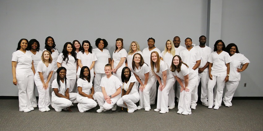 Twenty-four students graduated from East Mississippi Community College’s Practical Nursing program June 30 in a ceremony in the Lyceum auditorium. They are, from left: (back row) Brandi Wright, Michelle Sales, Kameshia Harris, Candace Blanton, Brittany Jana Evans, Anna Seawright, Shavonne Davidson, Montana Spencer, Wanda Holman, Kinishua Pierce, McKenzie Hancock, Jason Taylor, Davius Smith, Michael Wilson, Javockie Robinson, and Kanesha Johnson. In the back row, from left, are: Savannah Cummings, Tyneshia Shelton, Shametrius Sanders, Austin Harris, Niyah Brooks, Shelby Boulware, Heather Bailey, and Heather Brashears.