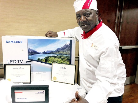 Sodexo Head Chef Johnny Boyd has been working at East Mississippi Community College’s Scooba cafeteria fulltime for 40 years, with an additional 5 years as a part time worker before that. Sodexo presented Boyd with a plaque for his 40 years of fulltime service, along with a flat screen TV. Also included here are plaques marking his 20th and 25th years of service in the cafeteria.