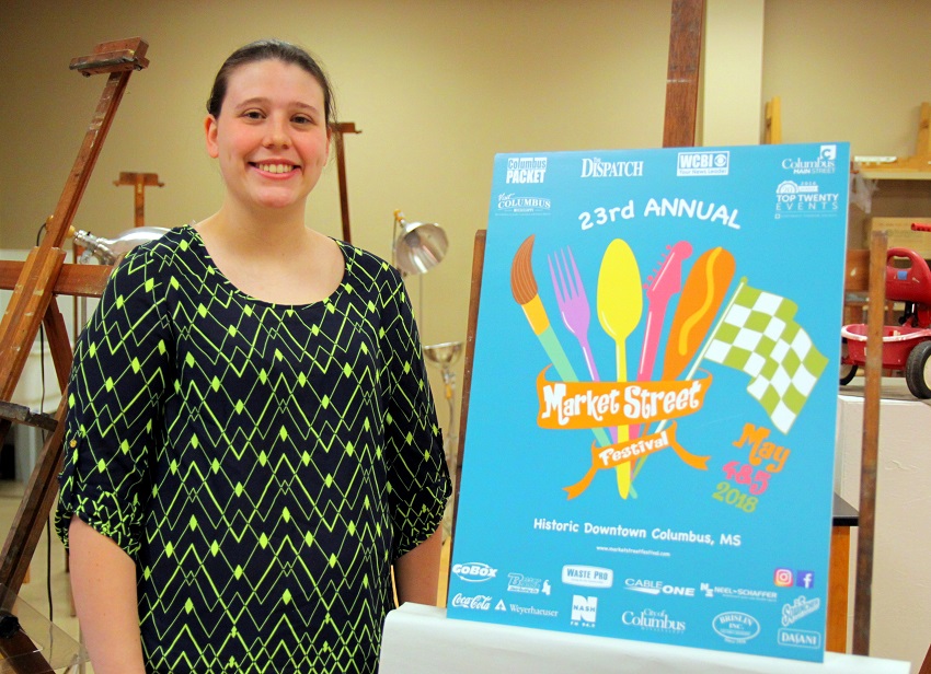 Former East Mississippi Community College student Kelly Brown with the winning design she came up with that is being used to promote the upcoming 23rd Annual Market Street Festival in Columbus.
