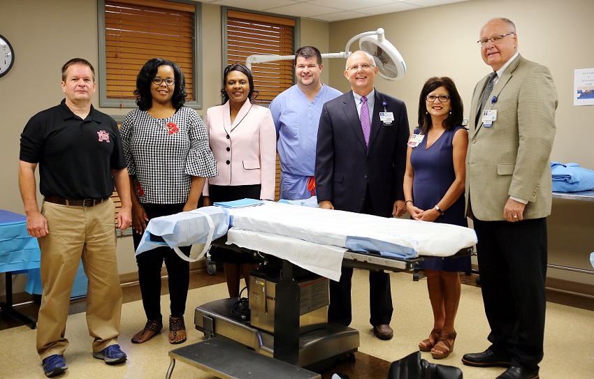 From left, East Mississippi Community College Paramedic instructor Chris Kelly, EMCC Surgical Technology Program instructor Janan Rush, EMCC Division of Nursing and Allied Health Director Dr. Tonsha Emerson, Baptist Memorial Hospital-Golden Triangle Director of Perioperative Services Derrick Forrester, Baptist Administrator and CEO Paul Cade, Baptist Chief Nursing Officer Mary Ellen Sumrall and Baptist Assistant Administrator Bill Lancaster in Baptist Golden Triangle’s training facility that will house two EMCC programs.