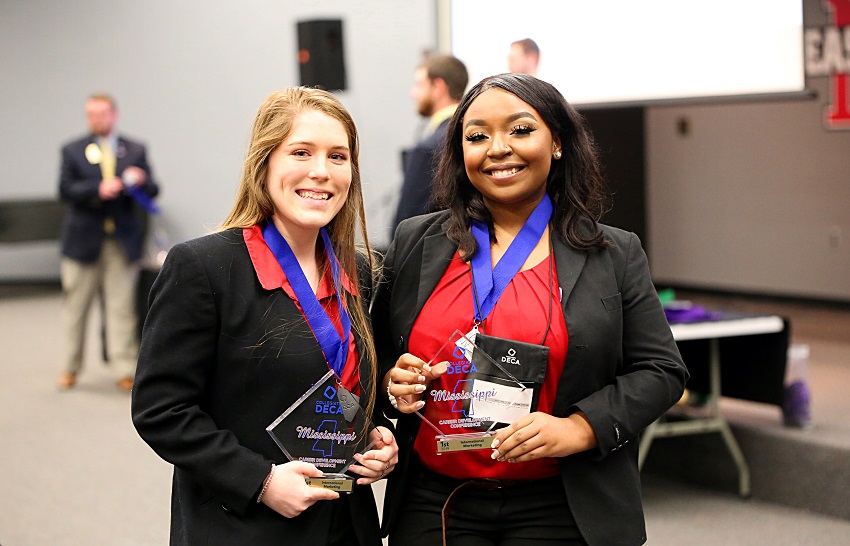 East Mississippi Community College students Laney Horne of Gulfport, at left and Destiny Jefferson-White of West Point and took first place in the International Marketing category during the Mississippi Collegiate DECA’s 2019 Career Development Conference. EMCC students won awards in 14 categories during the competition.