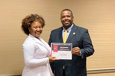 East Mississippi Community College Lion Academy graduate Sage Love, at left, is presented a certificate of completion by EMCC Associate Dean of Instruction James Rush.