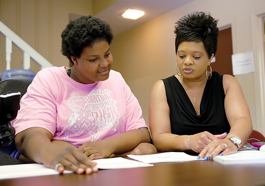 Macon resident Shaleta Odeneal, at left, goes over paperwork with East Mississippi Community College Macon Center Director Amanda Crawford. The EMCC Macon Center has expanded its program offerings and hours of operation.