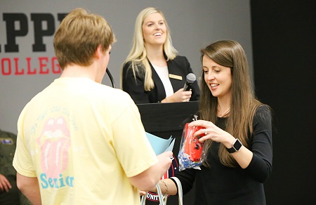 Columbus-Lowndes Chamber of Commerce Education Committee member Alison Alexander, at right, who is also an instructor at East Mississippi Community College, passes out door prizes at the chamber's "Senior Sendoff" event at the college.