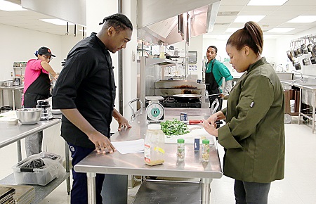 East Mississippi Community College Culinary Arts students Zavier Minor, at left, and Brittany Jackson, at right, prepare a dish during class. They are among a group of EMCC students who will present “Taste of Italy,” a four-course dinner at the EMCC Lion Hills Center.