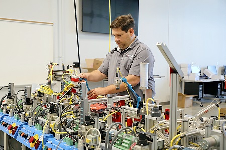 Electro-Mechanical Department Chair Ben Harris makes adjustments to equipment used to teach students enrolled in Mechatronics Technology and Systems Based Automation at The Communiversity at East Mississippi Community College. 