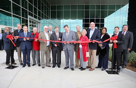 Then Mississippi Gov.-elect Tate Reeves, center, prepares to cut the ribbon during a grand opening ceremony for EMCC’s Communiversity that took place Oct. 18, 2019.