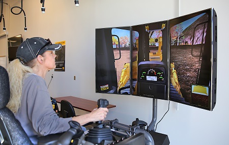 West Point resident Tammy Warren is enrolled in the Heavy Civil Construction course at The Communiversity at East Mississippi Community College. Here, Warren trains on a simulator used in the program, which has received Appalachian Regional Commission grant funds to purchase additional instructional equipment.