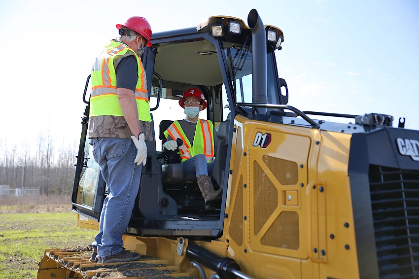 East Mississippi Community College Heavy Civil Construction instructor Carlton Ray Hollis, Sr., at left, gives student Tammy Warren pointers on the operation of a dozer used in the program. Appalachian Regional Commission grant funds will be used to purchase additional equipment for the program.