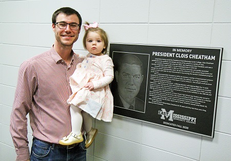 Daniel Cheatham and daughter, Roma Jane Cheatham, take a photo with a plaque honoring their grandfather and great-grandfather, former EMCC President Clois Cheatham, after a ceremony Monday night on EMCC’s Scooba campus. The plaque was unveiled in a dedication of the Science wing of Oktibbeha Hall.