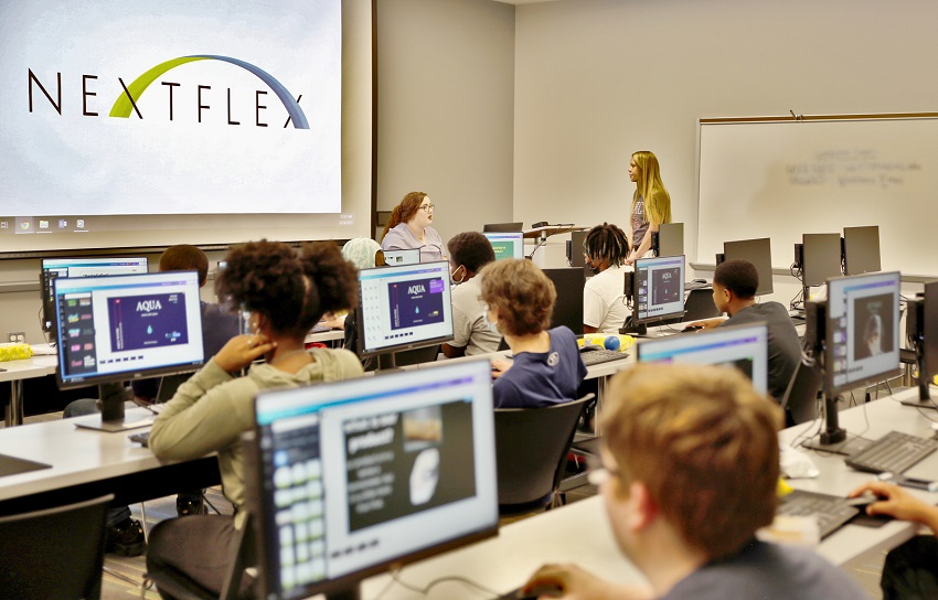 High school students enrolled in Camp AMP at The Communiversity at East Mississippi Community College work on a FlexFactor project under the guidance of Graduate Assistant Annie Price, seated, and EMCC FlexFactor Outreach Coordinator Camille Cooper, standing.