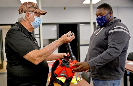 Heavy Civil Construction instructor Carlton Hollis, at left, shows student Jeremy Buie the correct usage of a safety harness. The course is now being offered at East Mississippi Community College’s Scooba campus. 