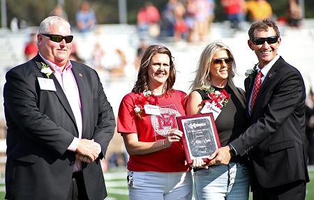 Kemper County Board of Supervisors member Mike Luke, who passed away Oct. 12, was named East Mississippi College’s 2022 Distinguished Service Award winner. He was recognized posthumously during EMCC’s Homecoming on Oct. 22. Here, Luke’s daughters, Amy Ivy, second from left, and Emily Lee, third from left, accept the award on their father’s behalf during halftime of EMCC’s Homecoming football game. Presenting the award are Dean of Scooba Campus/College Advancement Tony Montgomery, far left, and EMCC President Dr. Scott Alsobrooks, far right. 
