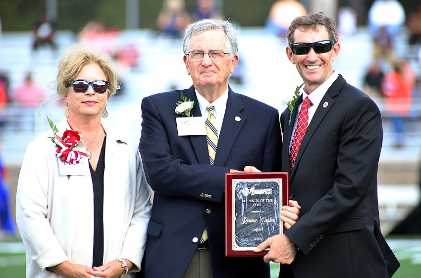 Columbus native Ronnie Carter, who resides in Tennessee, was named East Mississippi Community College’s 2022 Alumnus of the Year. Here, he is presented a plaque by Executive Director of Alumni Affairs and Foundation Operations Gina Cotton, at left, and EMCC President Dr. Scott Alsobrooks, at right, during halftime of the college’s Oct. 22 Homecoming football game. 
