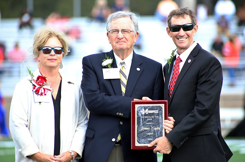 Columbus native Ronnie Carter, who resides in Tennessee, was named East Mississippi Community College’s 2022 Alumnus of the Year. Here, he is presented a plaque by Executive Director of Alumni Affairs and Foundation Operations Gina Cotton, at left, and EMCC President Dr. Scott Alsobrooks, at right, during halftime of the college’s Oct. 22 Homecoming football game.