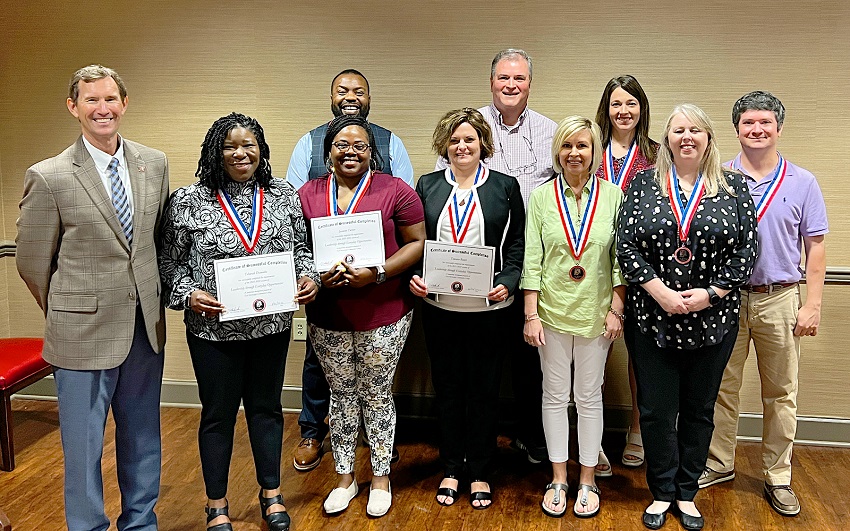 A graduation celebration took place April 22 for EMCC’s 2022 Class of Leadership Through Everyday Opportunities. Pictured at the celebration are, front row, from left, EMCC President Dr. Scott Alsobrooks, Director of Adult Education Tshurah Dismuke, Gateway Career Coach Jasmine Turner, Director of Recruiting/Recruiting Coordinator Tawana Bauer, Division Chair/Social Sciences & Business Jill McTaggart, and Biological Sciences instructor Christy Steadman. In the back row, from left, are EMCC Golden Triangle Police Department Lt. Barry Johnson, EMCC Vice President of Operations Dr. Paul Miller, Biological Sciences instructor Ashley Richardson, and QEP Navigator Matthew Darnell. Not pictured is GTECHS Biology instructor Brandy Burnett. 