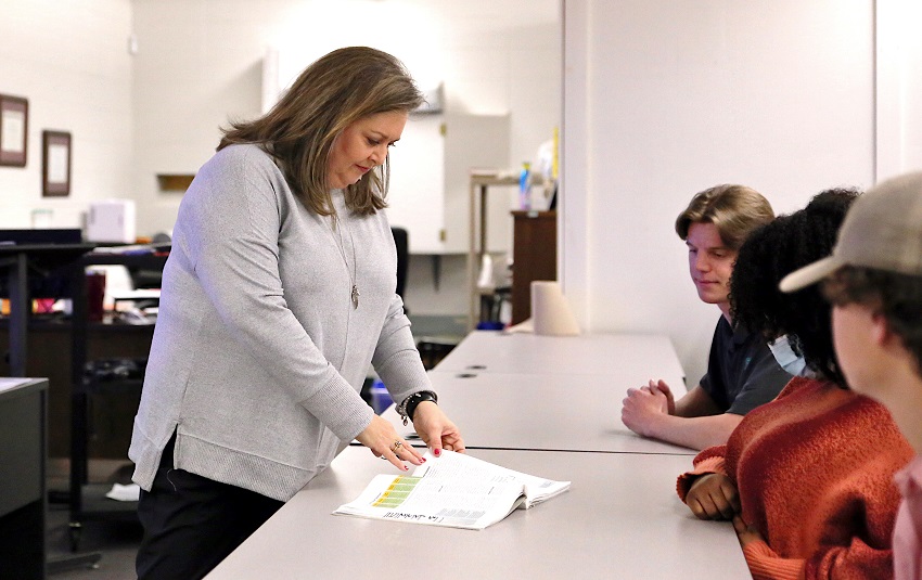 East Mississippi Community College Business and Marketing Management Technology program instructor Shannon Miller, at left, goes over an assignment with students in one of her classes.