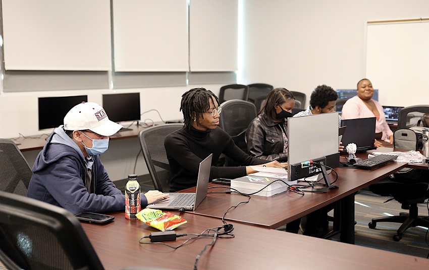 Students enrolled in the Mississippi Coding Academies program at East Mississippi Community College’s Communiversity work on their classroom assignments in this file photo taken prior to the college’s latest indoor mask mandate. 