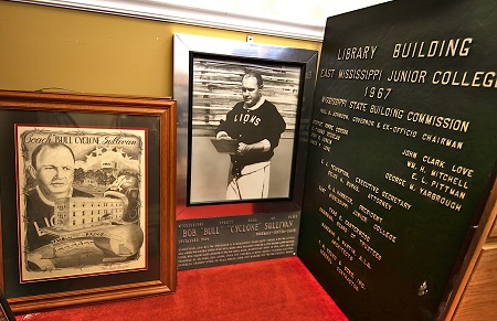 EMCC has items in storage that would be displayed in Wallace Hall if it is converted into a museum, such as this painting and photo of legendary football coach Bob “Bull” Sullivan and sign for the library building.