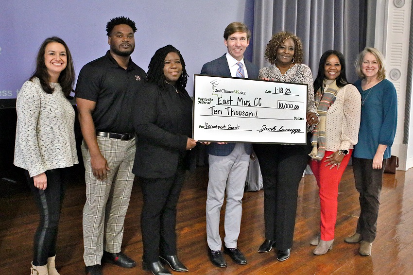 2nd Chance MS Executive Director Zach Scruggs, center, presented East Mississippi Community College’s Adult Education Launch Pad with a ceremonial check on Wednesday, Jan. 18, to help fund a new initiative. Scruggs was accompanied by 2nd Chance MS Program Director Sarah Rose Lomenick, at left. Members of EMCC’s Adult Education department at the check presentation are, from left, MIBEST College and Career Navigator Jeremy Tate, Adult Education Director Tshurah Dismuke, Assistant Adult Education Director/College and Career Navigator Mary Ann Latham, Adult Education and Smart Start Lead Instructor Geneva Atkins, and Adult Education Instructor Suzy Houston.