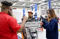 East Mississippi Community College Automotive Technology students Donte Smith of Pheba, at left, Reggie Roberson of Louisville, center, and Izzy Latham of Starkville works on an electrical vehicle trainer