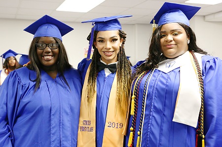 Alexis Turner, at right, is pictured here during her May 2019 graduation from the Golden Triangle Early College High School, along with classmates Nyasia Harkins, at left, and Demarcus Henley. Turner is employed as a mathematics teacher in Starkville and is working on her Master of Arts in Teaching degree at the Mississippi University for Women. 