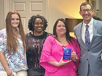 East Mississippi Community College President Dr. Scott Alsobrooks, at right, presents members of the Business Office with the BankMobile Disbursements ACE Award. Pictured, from left, are Taylor Warren, Donnika Hairston and Margaret Aldridge. Not pictured are EMCC Chief Financial Officer Tammie Holmes and Business Office members Carolyn Stringfellow, Patricia Patterson, Kiara Rush, Laura Gutherie and Tonya Hunt.