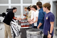 East Mississippi Community College Assistant Band Director Ben Neal, at left, instructs students during a March 25 band clinic at New Hope High School. EMCC and New Hope sponsored the band clinic for middle and high school students.