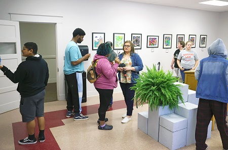 Visitors during East Mississippi Community College’s Pine Grove Arts Festival last year look over an art exhibit in Aust Hall on the college’s Scooba campus. This year’s festival will also include an art exhibit and pottery sale in Aust Hall. The festival returns this year April 2-3 on the Scooba campus and April 9 on the college’s Golden Triangle campus.