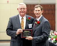 In this file photo, Richard Poole, at left, receives a plaque from East Mississippi Community College Dr. Scott Alsobrooks during Poole’s 2019 induction into the college’s Sports Hall of Fame. Poole, who is EMCC’s 2025 Alumnus of the Year, was unable to attend the college’s annual Homecoming when the Alumnus of the Year recipient was announced. 