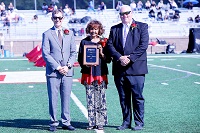 Linda Jackson, at center, is EMCC’s 2025 Distinguished Service Award recipient. She was recognized here during halftime of EMCC’s Oct. 11 Homecoming football game by EMCC President Dr. Scott Alsobrooks, at left, and Dean of Scooba Campus/College Advancement Tony Montgomery.