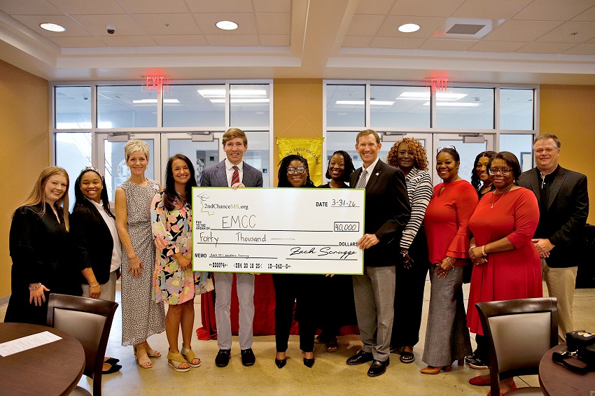 East Mississippi Community College President Dr. Scott Alsobrooks, at right holding check, receives a ceremonial check from 2nd Chance MS Executive Director Zach Scruggs, at left holding check, to fund short-term training programs for students enrolled in the Adult Education Launch Pad at the college. EMCC Adult Education Director Tshurah Dismuke is pictured between Alsobrooks and Scruggs. They are accompanied Adult Education faculty and staff, as well as Bronwyn Robertson, assistant director for WIOA Compliance for the Mississippi Community College Board’s Office of Adult Education, and 2nd Chance MS Program Director Sarah Lomenick.